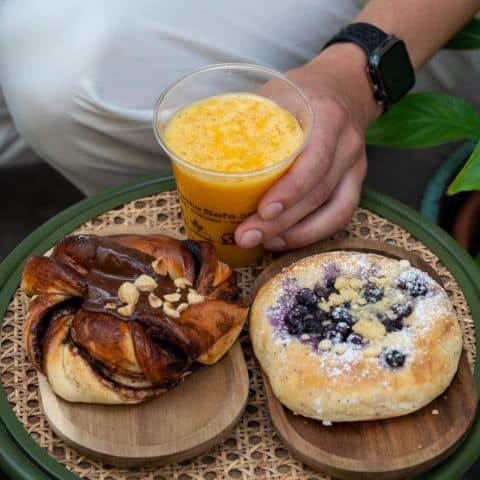 Sweet pastries on the table in bakeshop with fresh juice